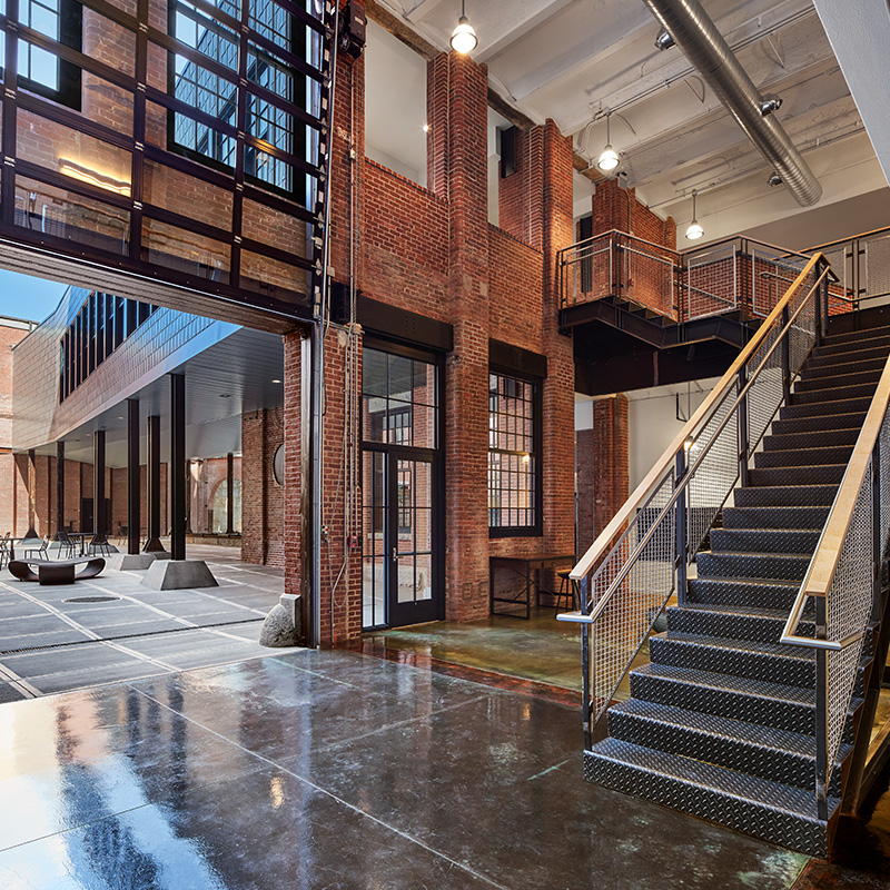 Industrial-style stairwell with glossy cement floors and ironwork