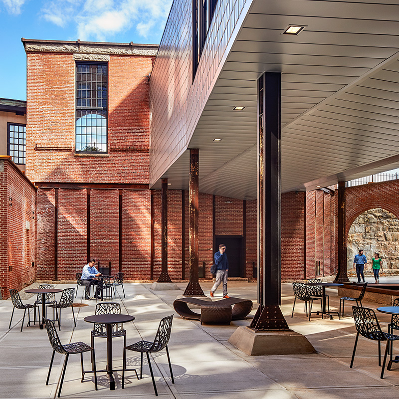Outdoor courtyard with restored steel framing and masonry