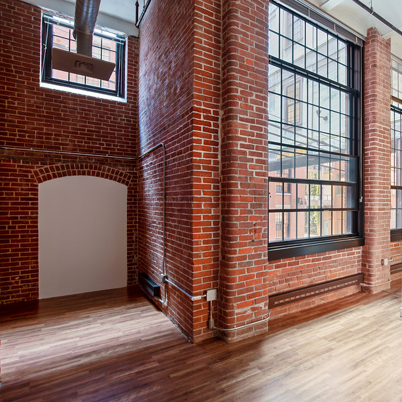 industrial style loft apartment with red brick walls and windows